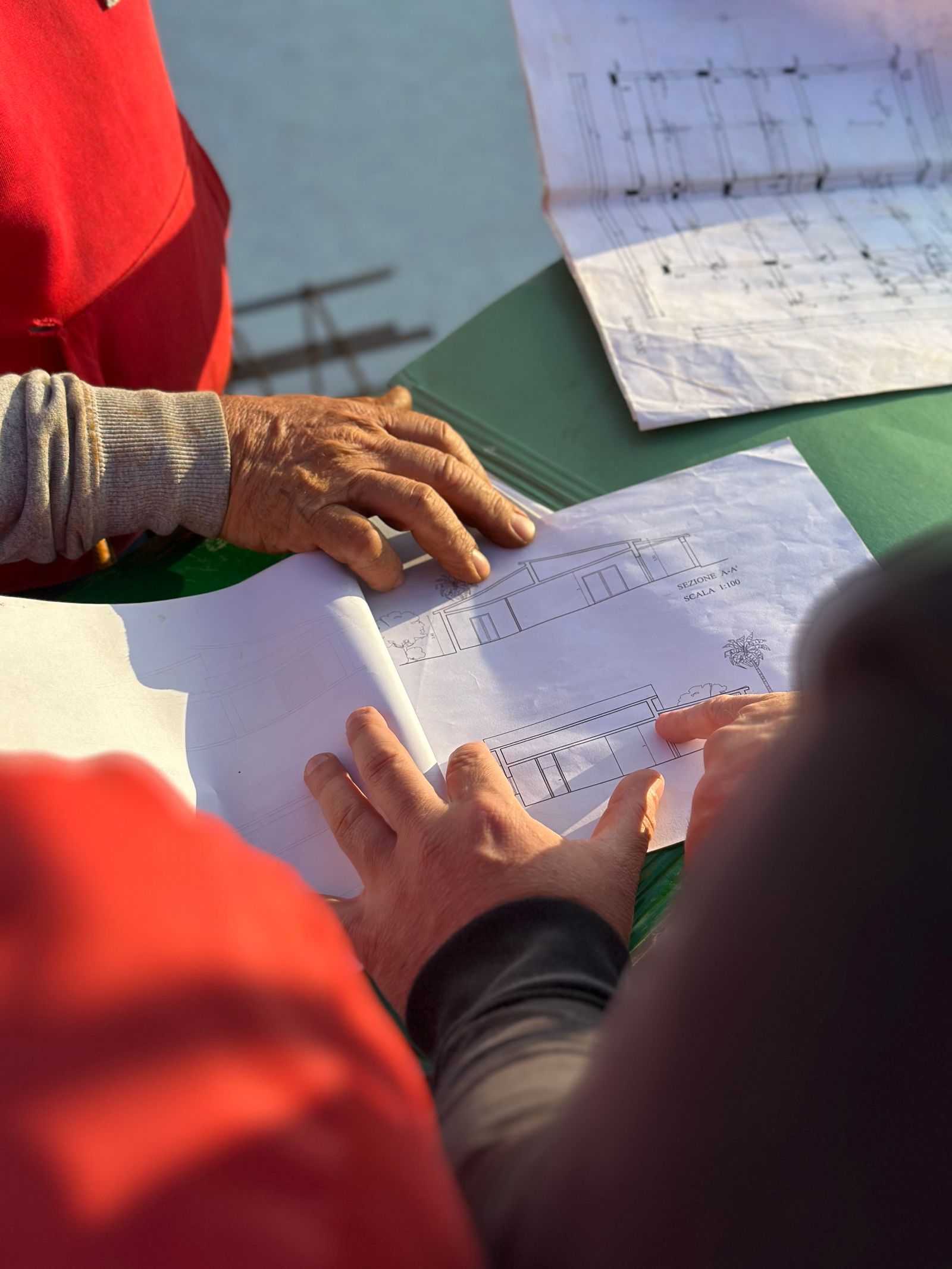 Construction professionals reviewing architectural blueprints on site