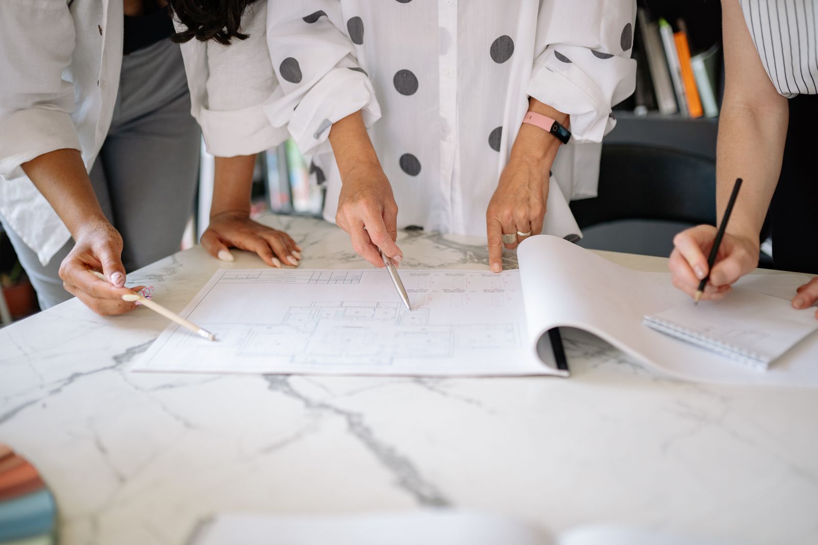 Project team collaborating over architectural plans