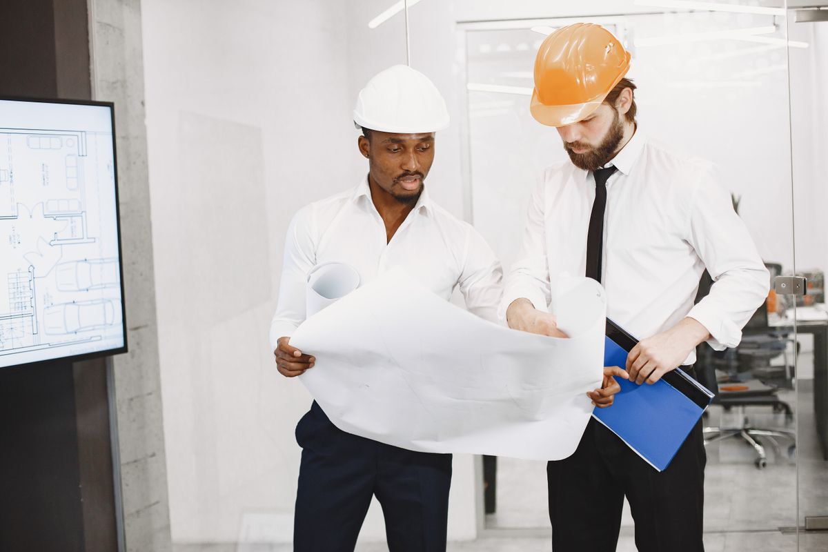 Construction professionals coordinating project plans in an office