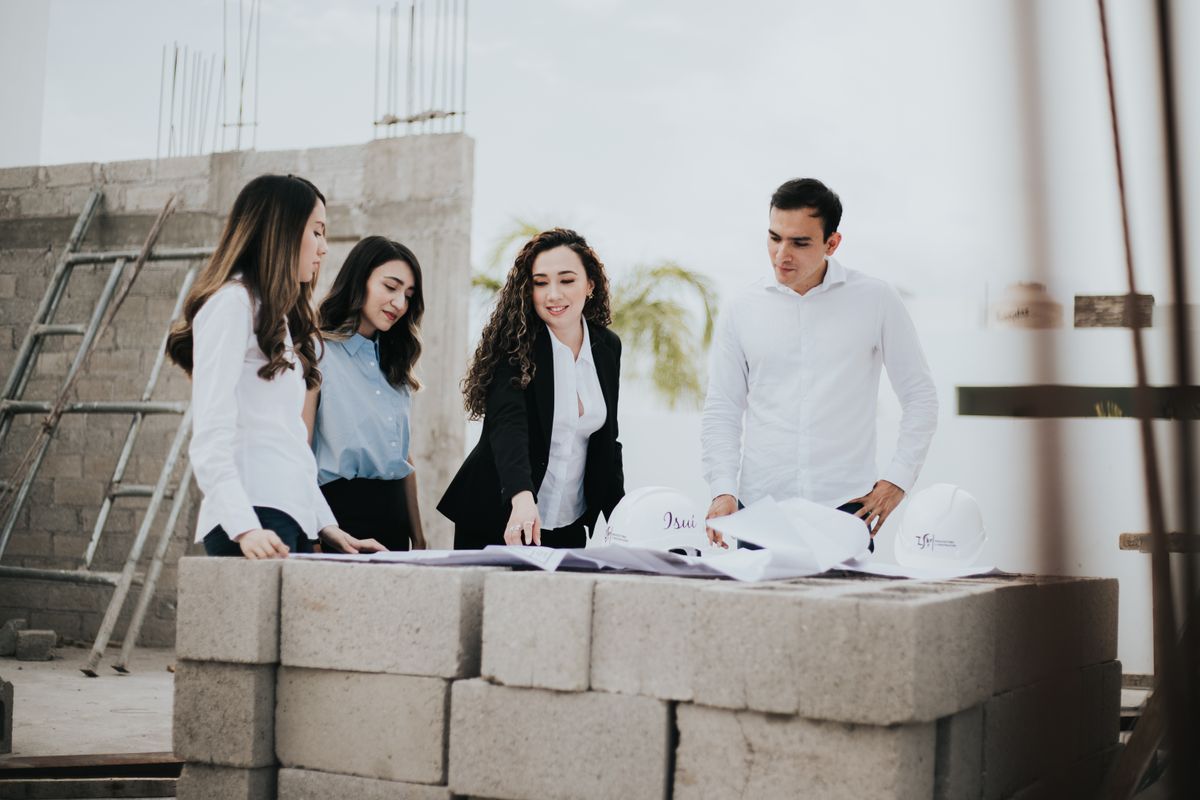 Project team discussing plans at an active construction site