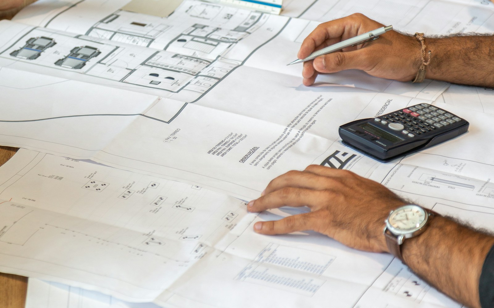 Professionals reviewing construction plans and project calculations