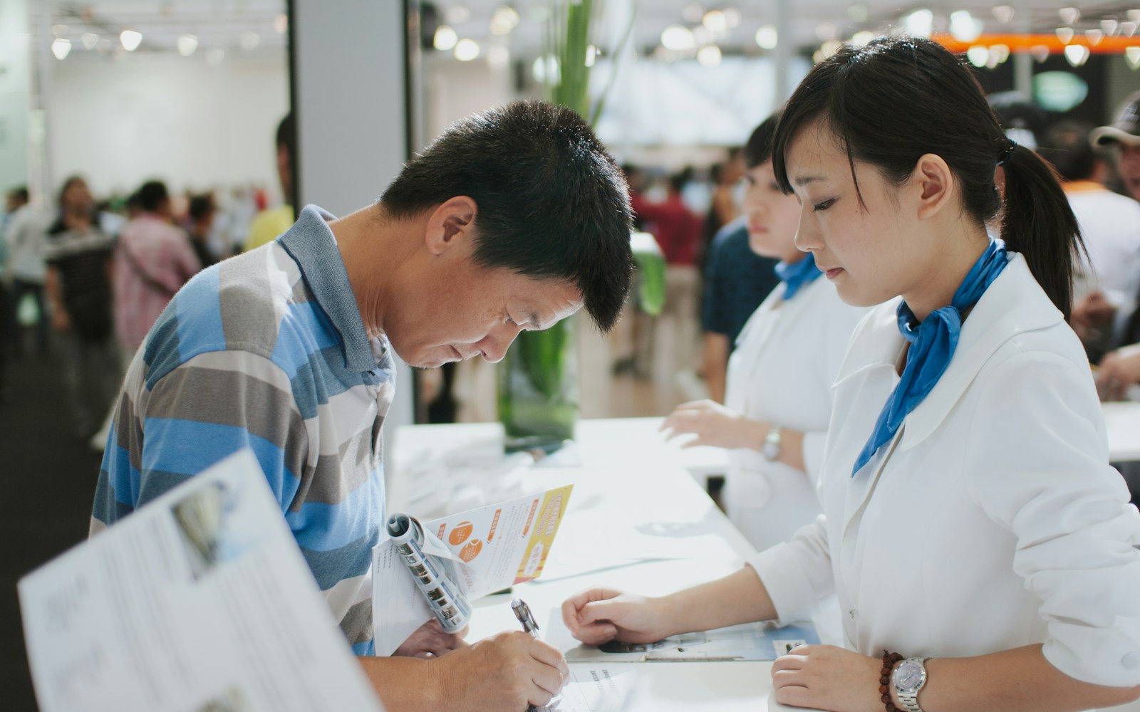 Citizen completing a document at a public service counter