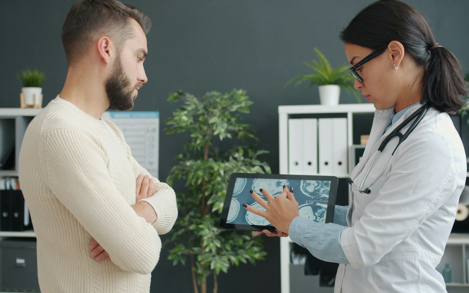 Doctor reviewing a digital medical record with a patient