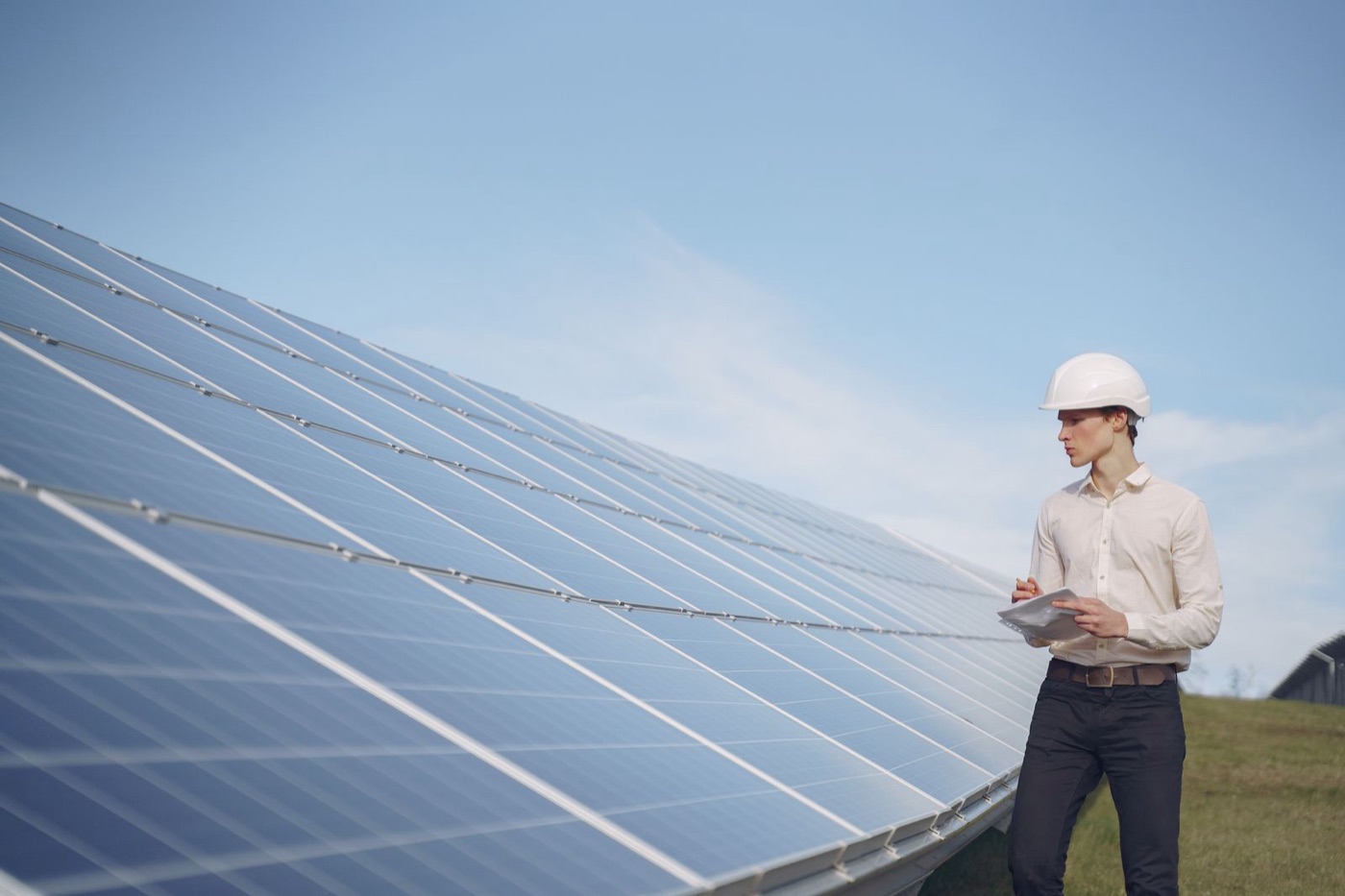 Renewable energy technician inspecting a solar panel installation