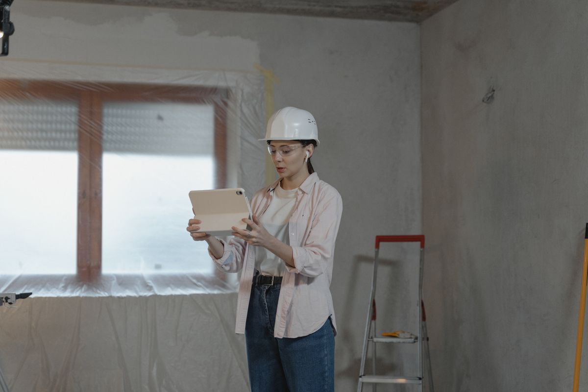 Facilities professional using a tablet during an indoor building inspection
