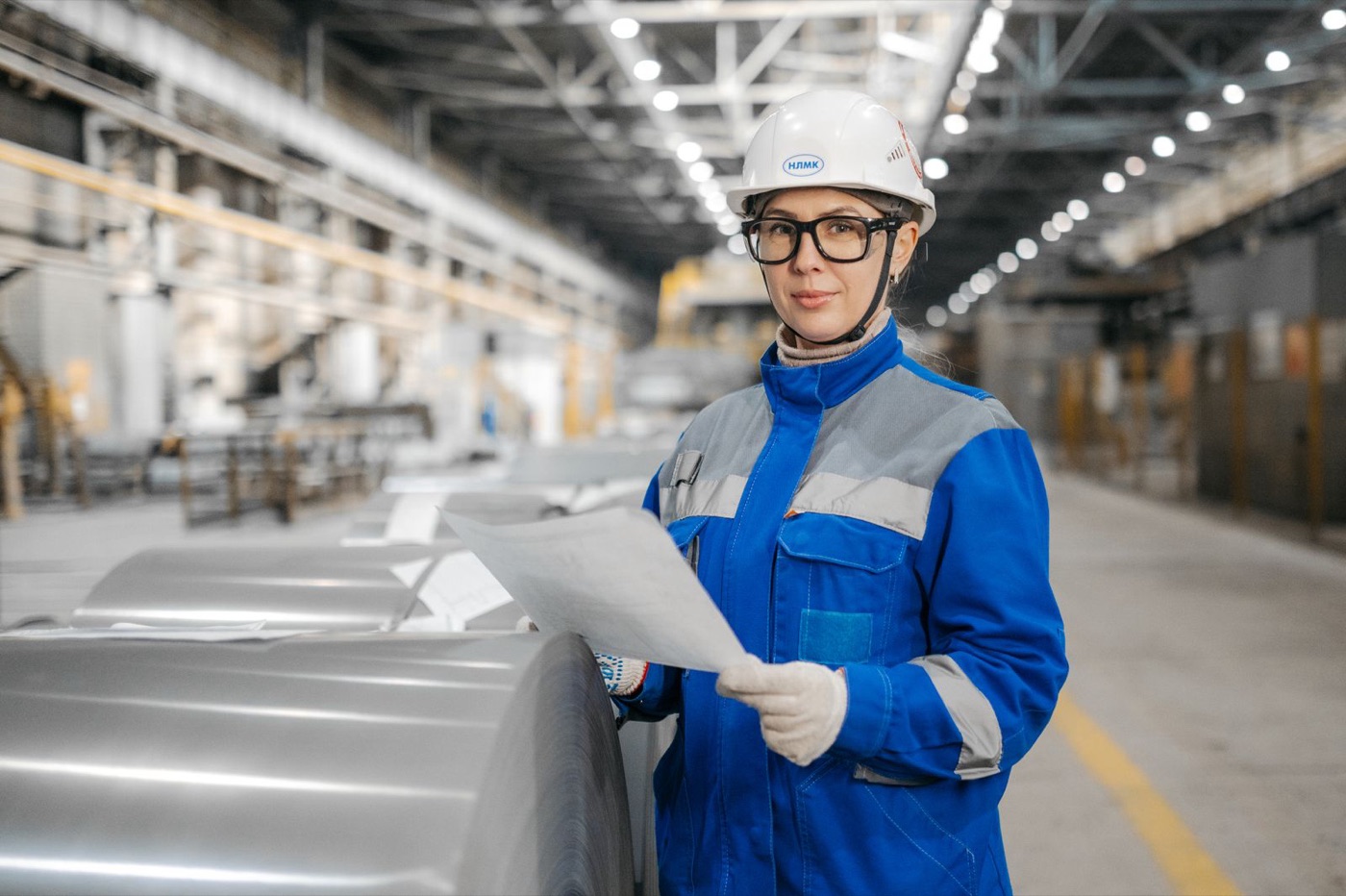 Industrial maintenance professional reviewing equipment documentation in a plant
