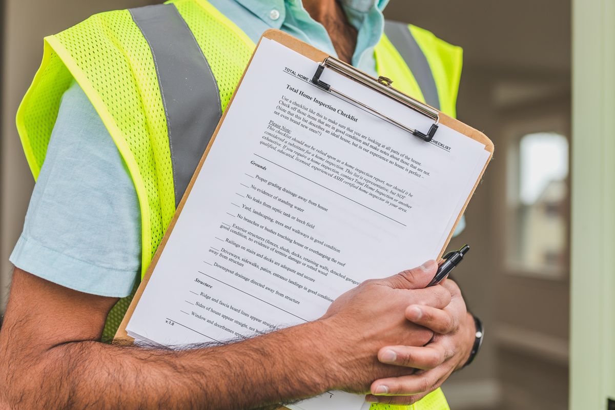 Field inspector carrying a property inspection checklist